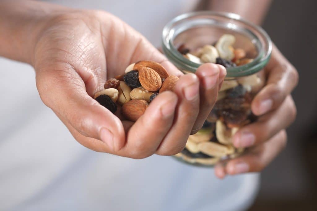 Handful of nuts and raisins showing magnesium foods anxiety snack option