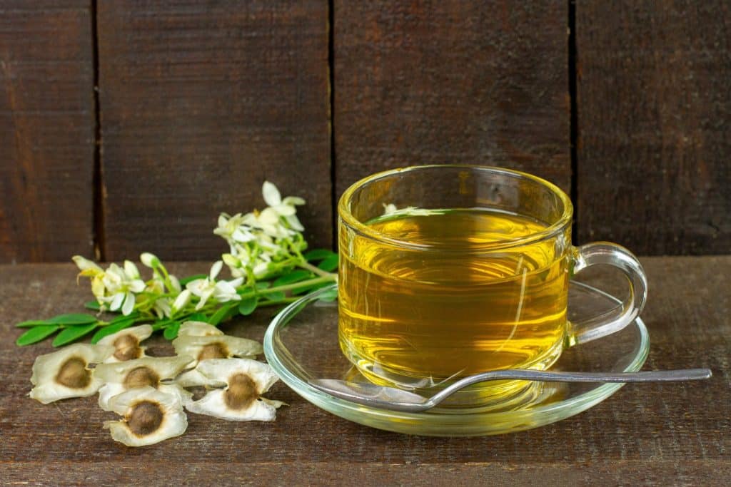 Moringa tea with seeds highlighting moringa benefits