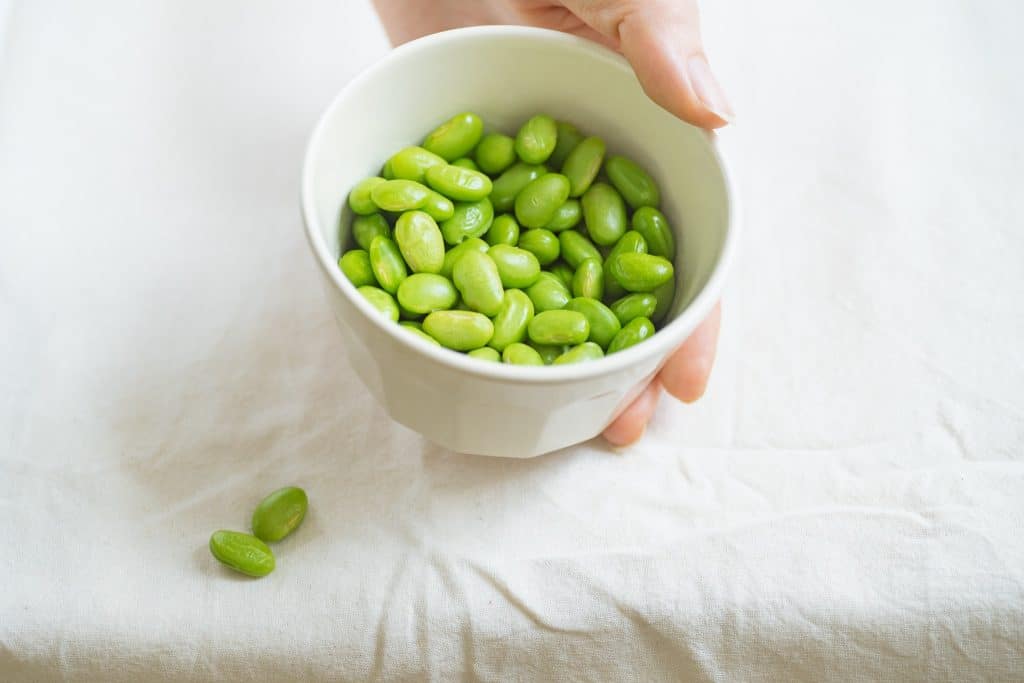 Shelled edamame in a white bowl