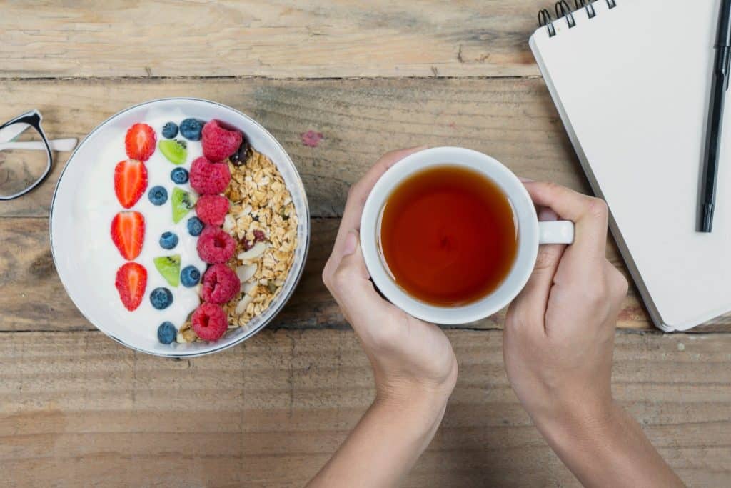 Healthy yogurt bowl and tea as simple snacks for work