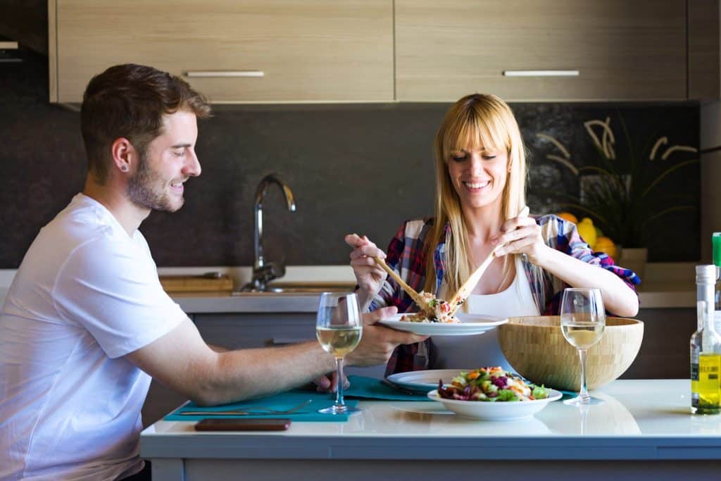 Couple sharing a quinoa and millet dinner, highlighting the everyday benefits of ancient grains in balanced diets.