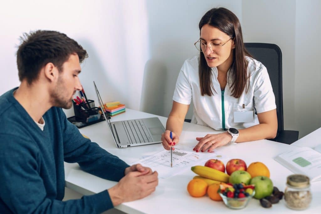 Dietitian explaining postbiotics gut health benefits during a nutrition consultation