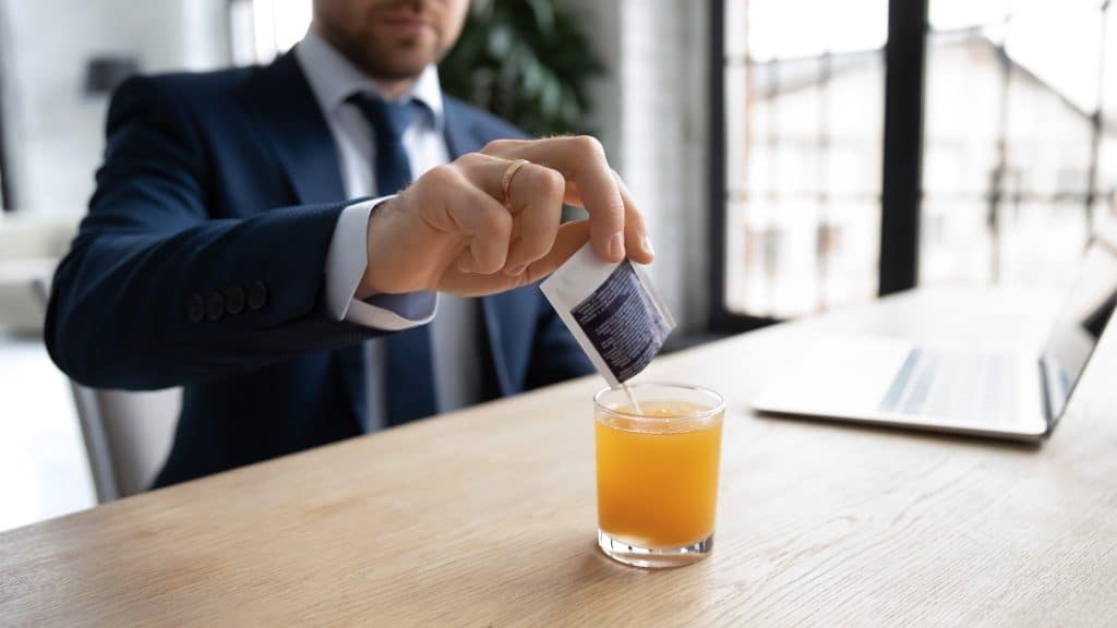 Man mixing vitamin drink for baobab powder benefits.