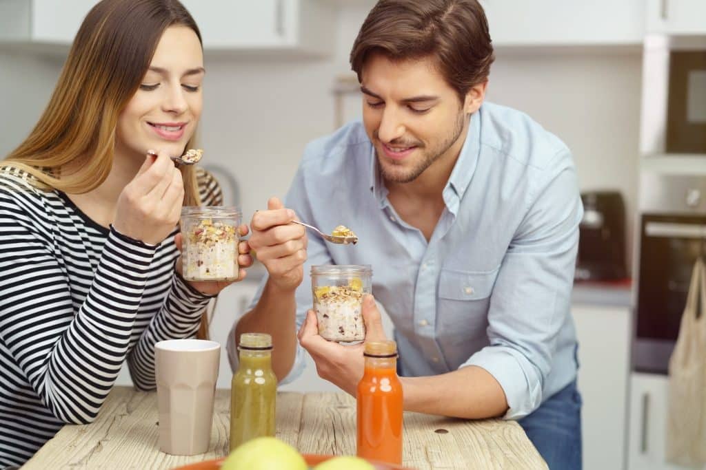 Couple enjoying overnight oats with baobab powder benefits.