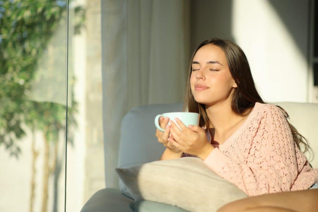 Relaxed woman enjoying coffee calmly showing balanced caffeine and anxiety