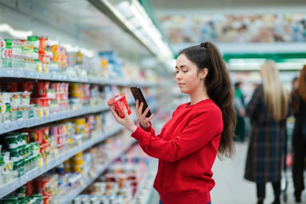 Customer reads package label and QR code while shopping
