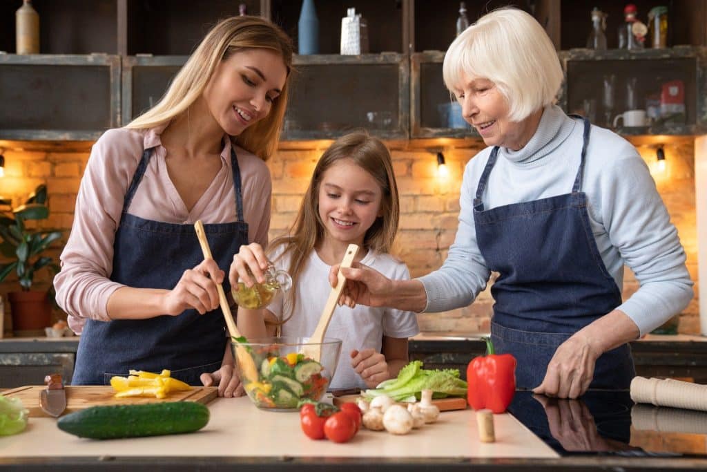 Family preparing salad with fresh functional mushrooms in the kitchen