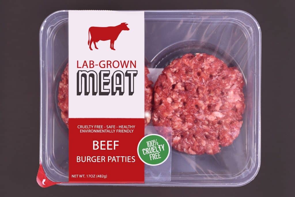 Packaged lab grown meat patties in supermarket tray