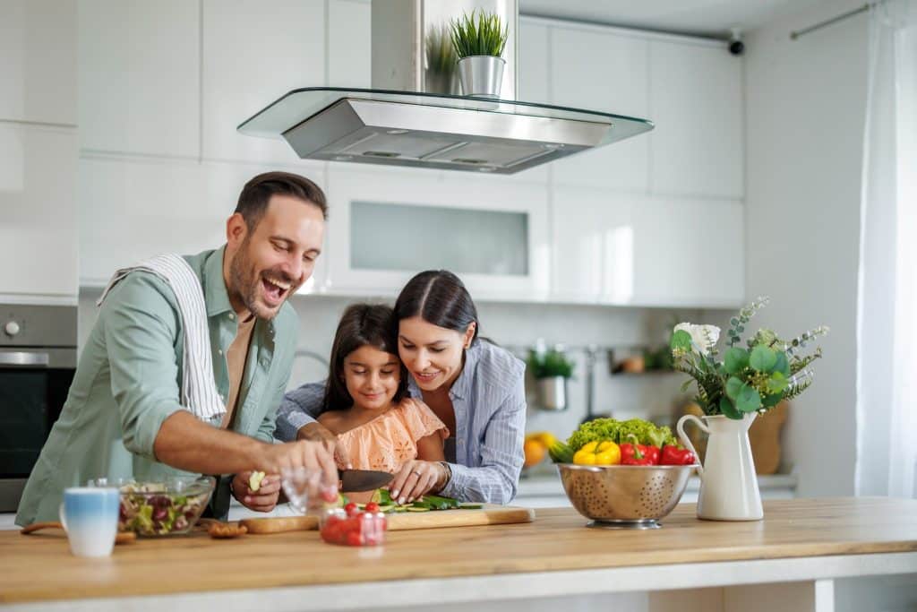 Family preparing low FODMAP foods together in home kitchen
