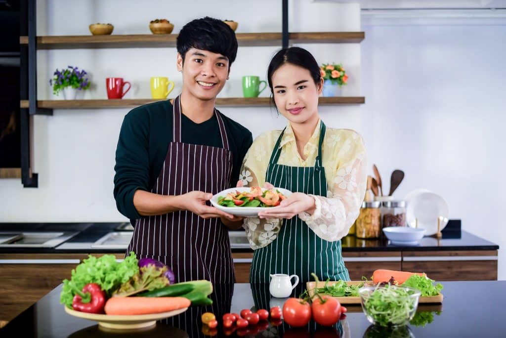 Couple showing homemade plant based seafood dish