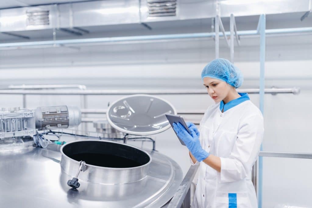 Worker monitoring fermentation tanks for precision fermentation dairy