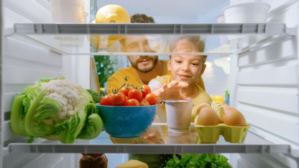 Family reaching for yogurt made with precision fermentation dairy