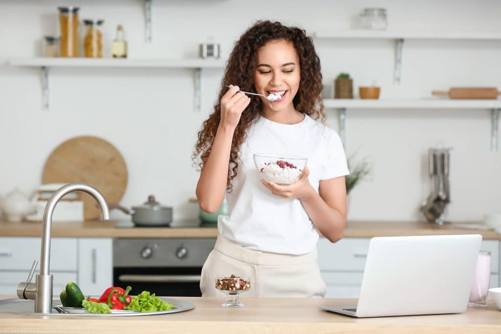 Woman tasting cottage cheese snacks high protein.