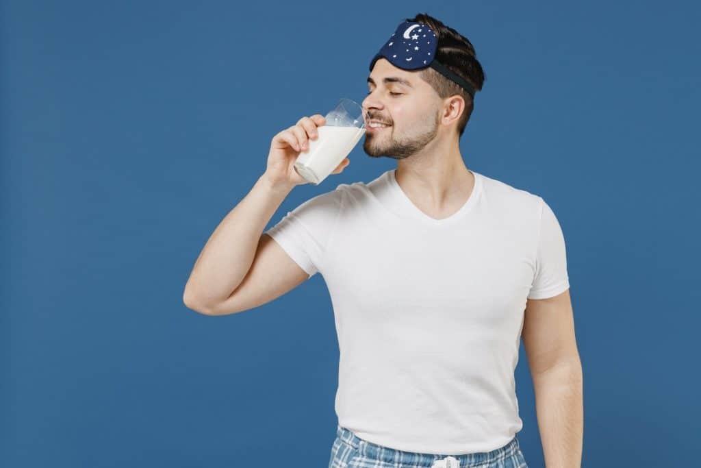 Man drinking warm milk before bedtime