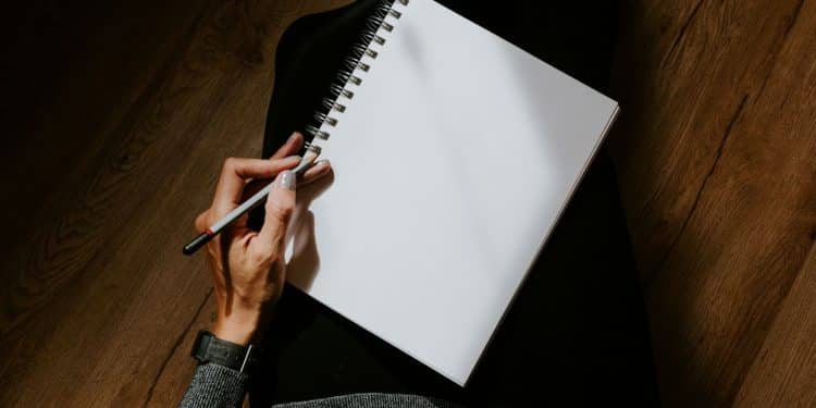 person writing on white paper